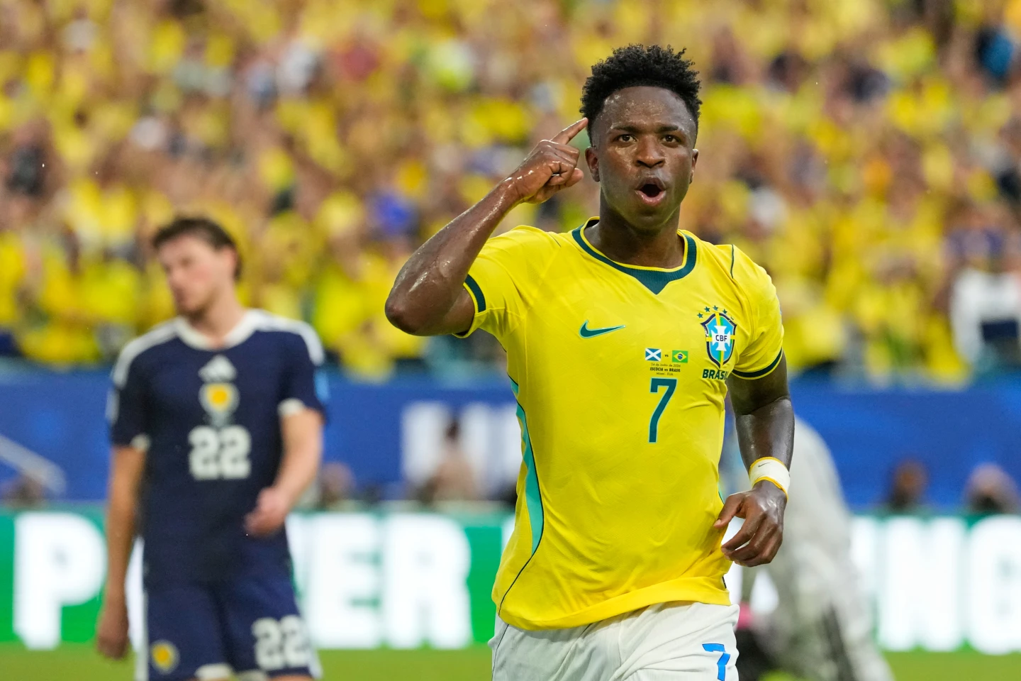 Vinícius Júnior celebrates after scoring for Brazil against Scotland.